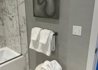 A bathroom with a bathtub and a towel rack.