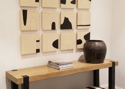 A wooden table with black and white art on it.