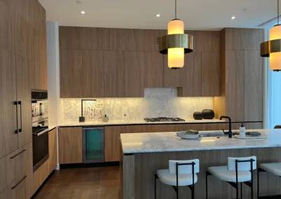 A kitchen with a marble island and a light fixture.