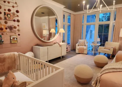 A baby's room with a crib, dresser, and a mirror.